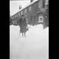 thumbnail Mrs Frost alonside the now demolished High Street 'Crown Cottages' in the early 20th century